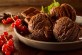 Close Up Still Life of Scoops of Gourmet Chocolate Ice Cream Garnished with Red Currants and Chocolate Bar Squares in Large Dish