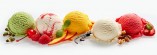 Set of ice cream scoops of different colors and flavours with berries, nuts and fruits decoration isolated on white background