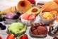 Set of ice cream scoops of different colors and flavours with berries, chocolate and fruits on table